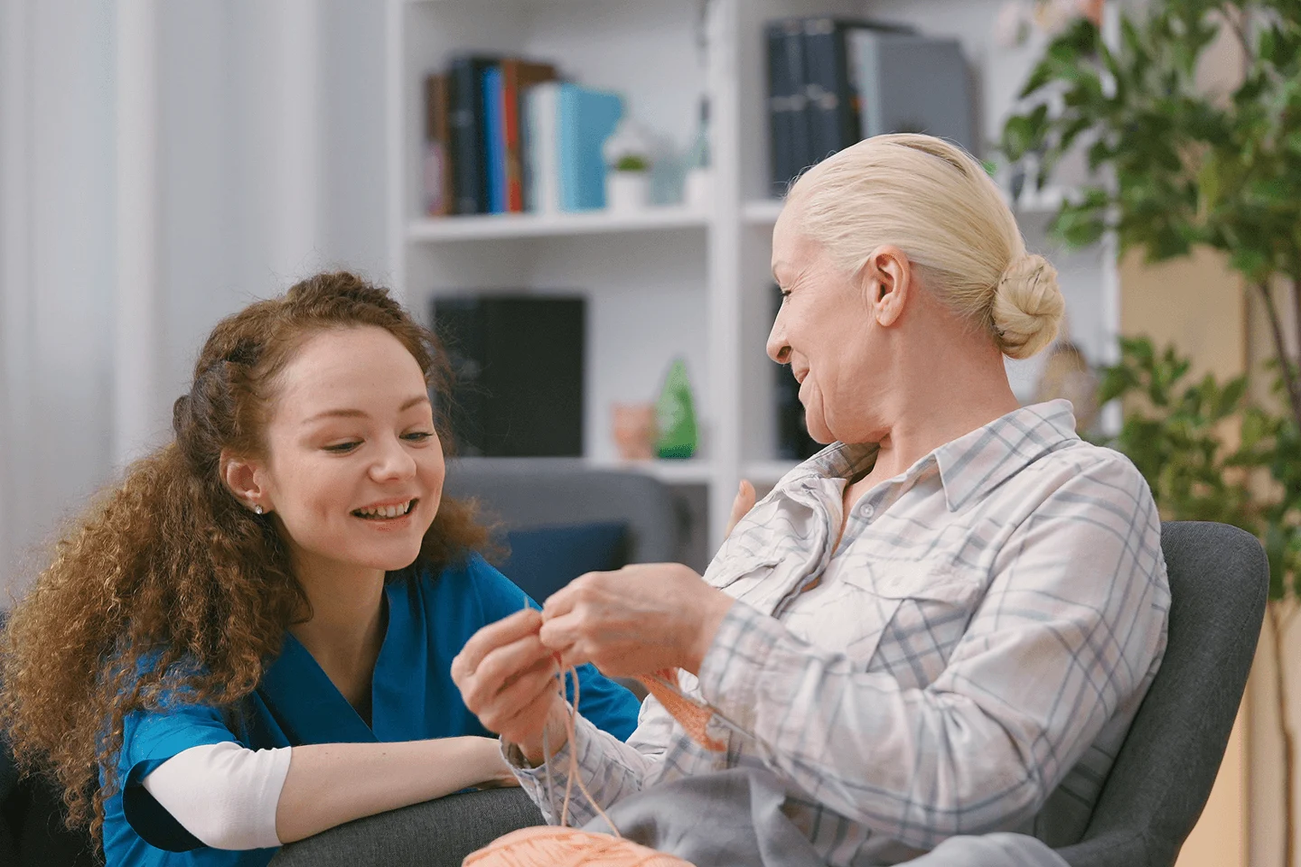 Therapist assisting an elderly client during a therapy session