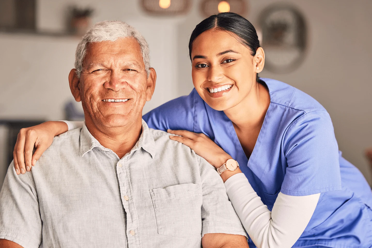 Caregiver and senior smiling together